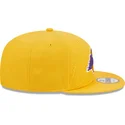 kepure-plokscia-geltona-snapback-9fifty-draft-edition-2023-los-angeles-lakers-nba-new-era